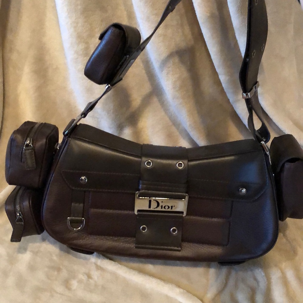 Brown leather Dior purse with multiple pockets.